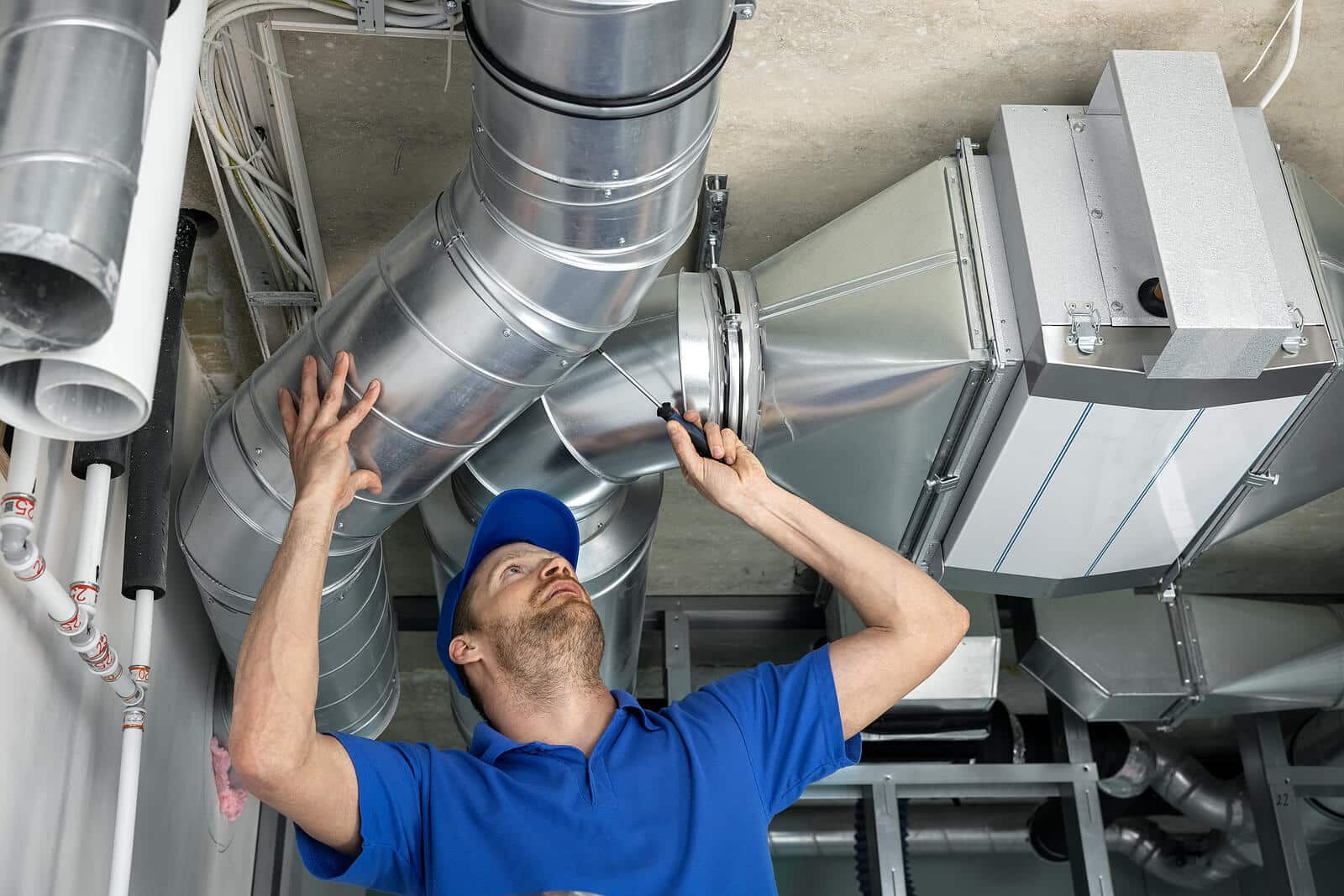 HVAC technician inspecting and repairing air ducts in Seal Beach