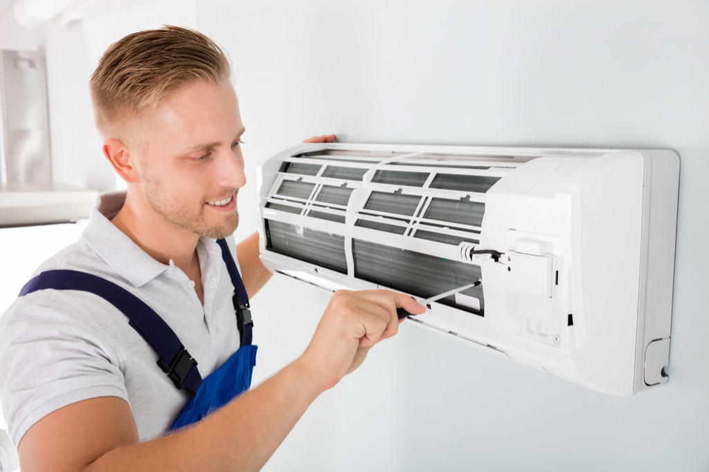HVAC technician maintaining a ductless air conditioner in Seal Beach