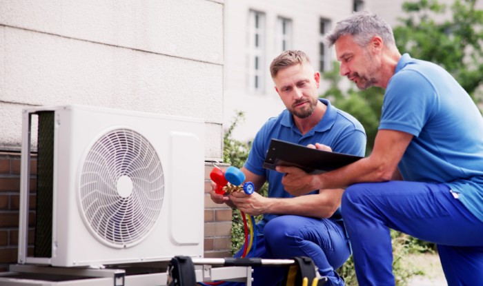 HVAC technicians installing an outdoor air conditioning unit in Seal Beach