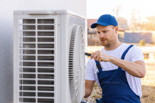 HVAC technician servicing an outdoor air conditioner in Seal Beach