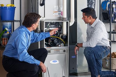 Technician evaluating a furnace for repair or replacement in Seal Beach
