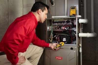 Heating technician diagnosing a furnace repair in Seal Beach