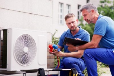 HVAC technicians installing an outdoor air conditioning unit in Seal Beach