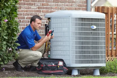 HVAC technician inspecting an outdoor AC unit in Seal Beach
